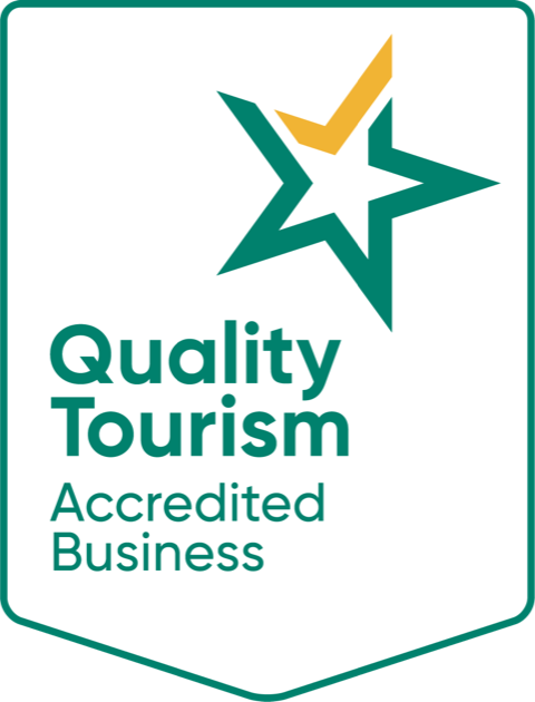 A quality tourism accredited business logo with a green star