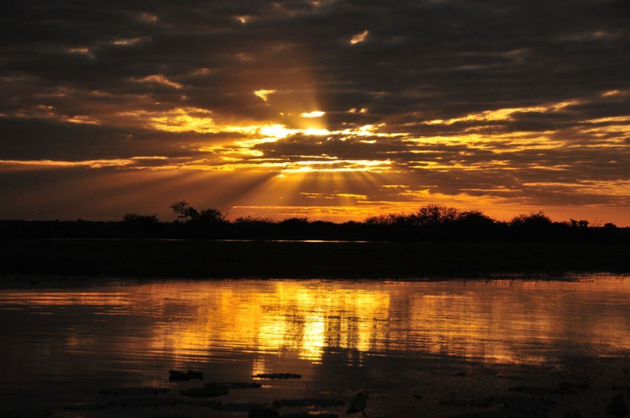 The sun is setting over a body of water