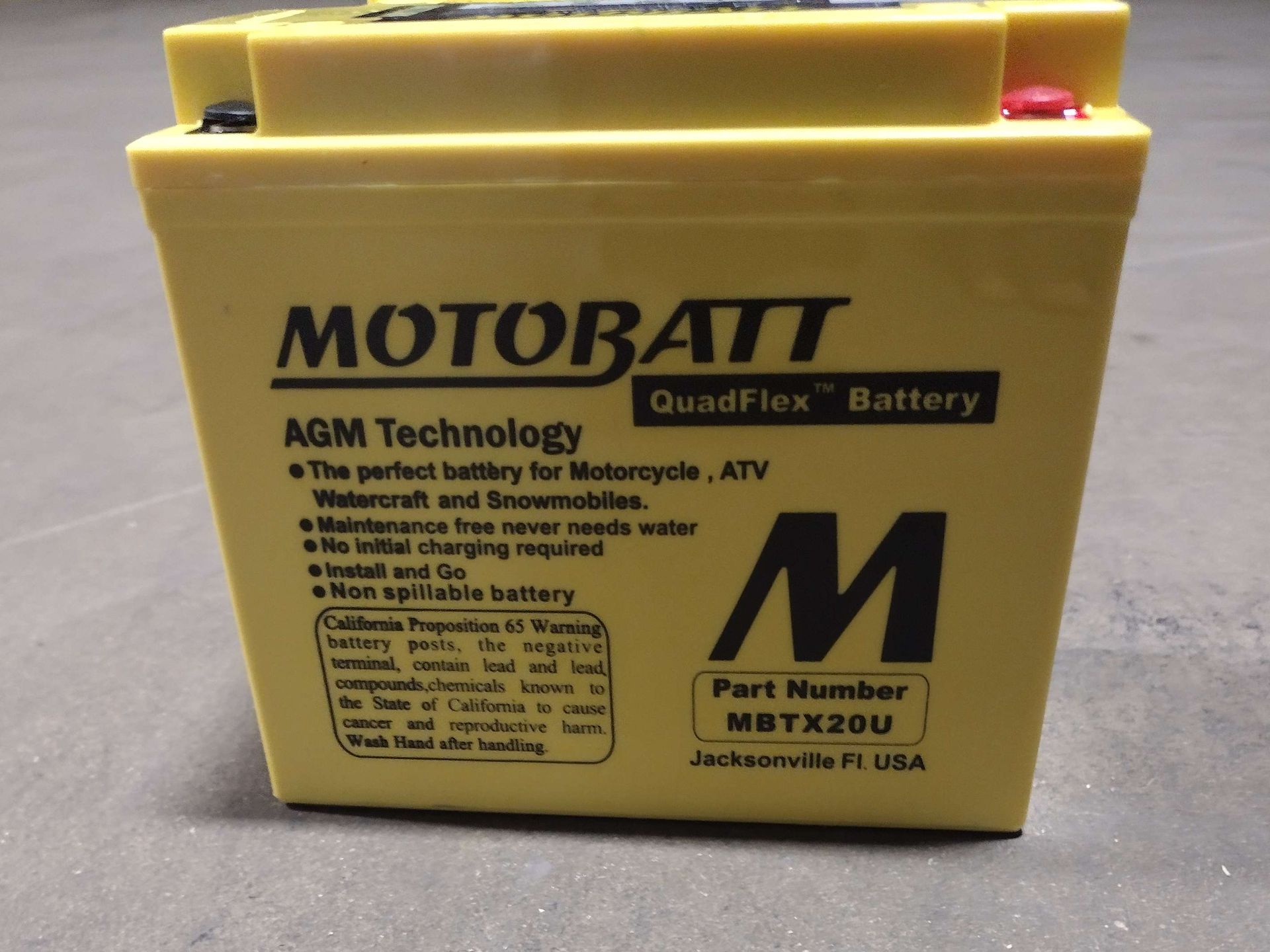 Yellow motorcycle battery with black lettering: 