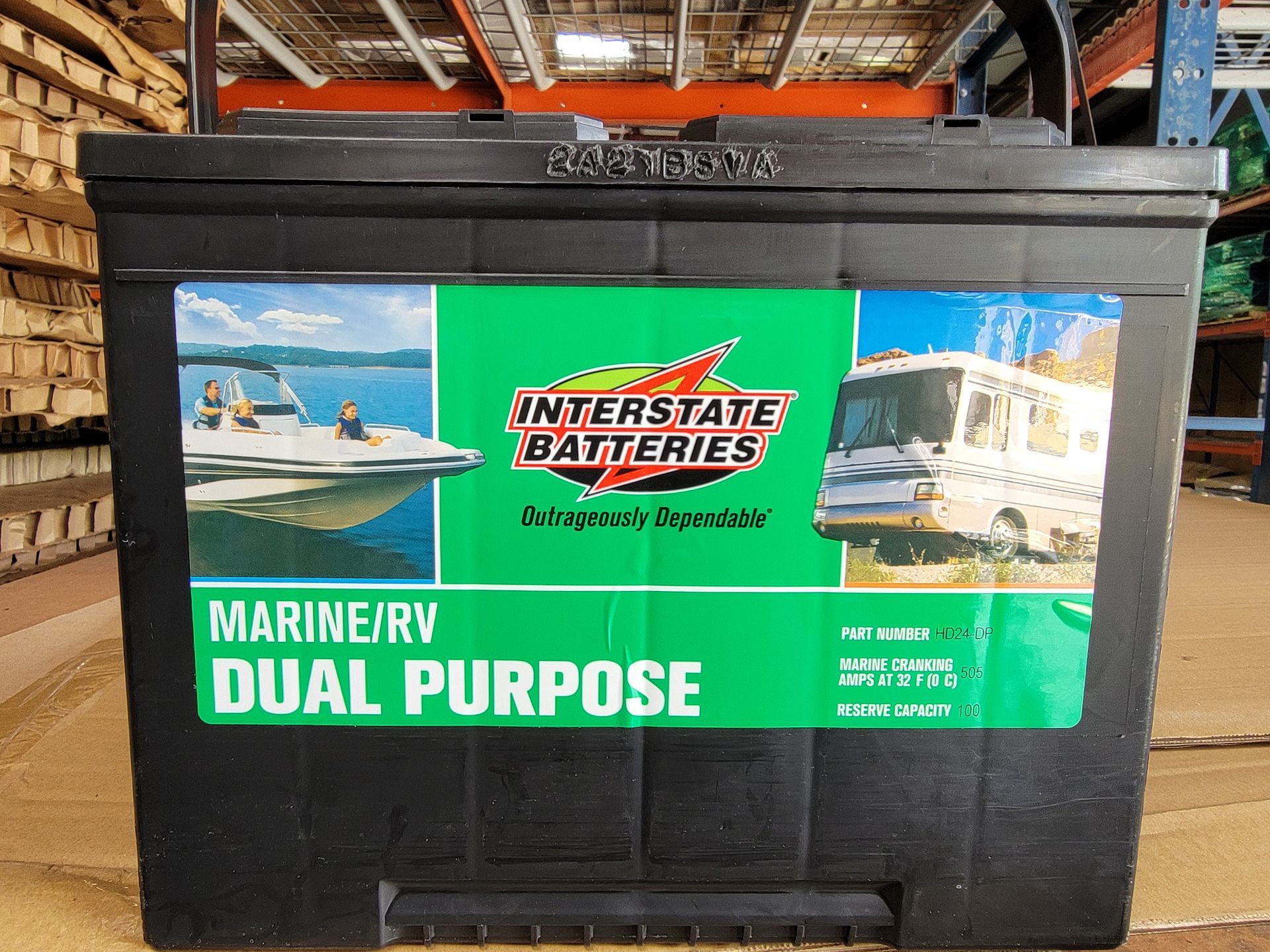 Black Interstate Marine/RV dual-purpose battery with green and white label, boat and RV images.