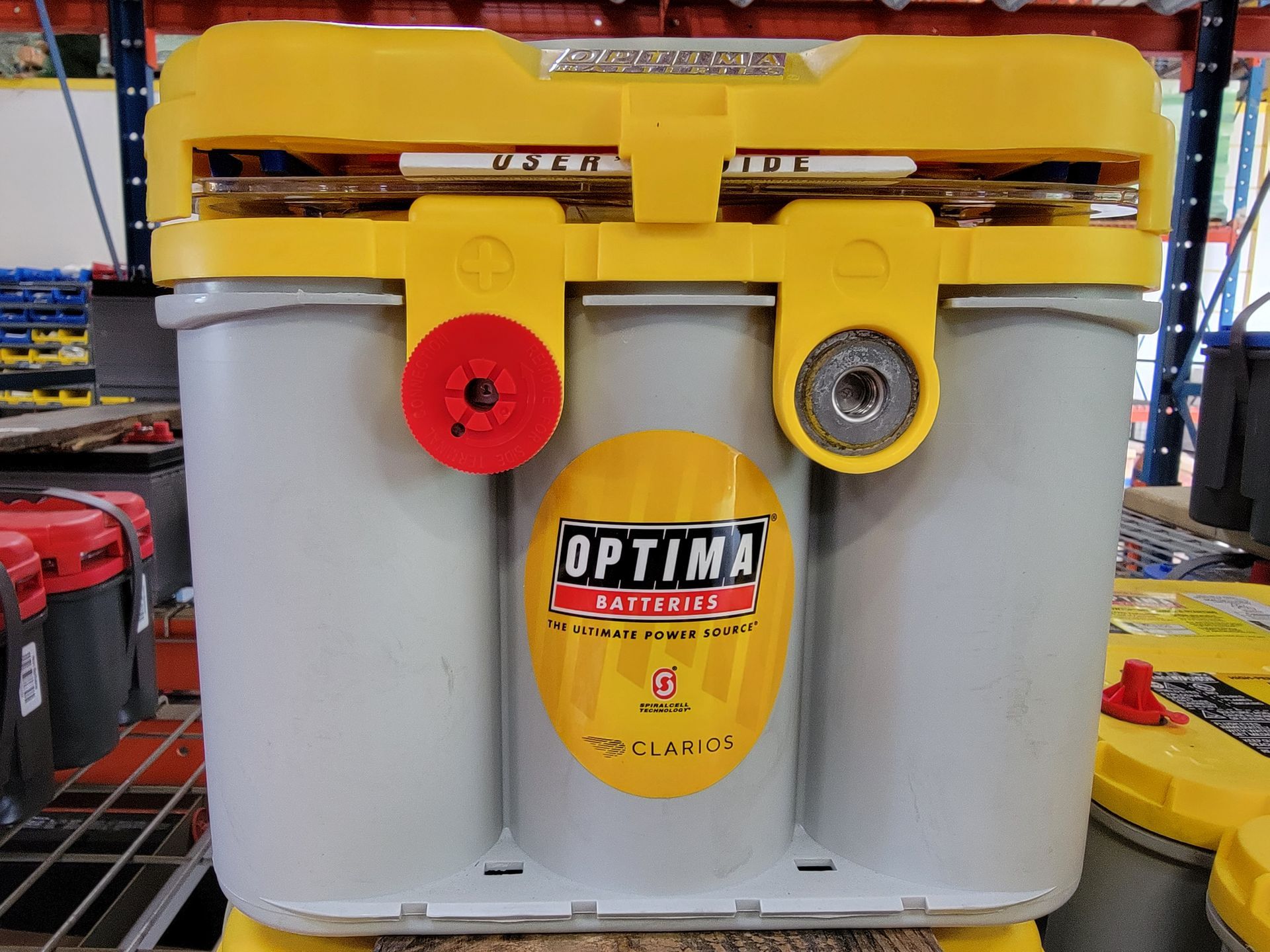 Optima yellow-topped car battery with red and silver terminals.