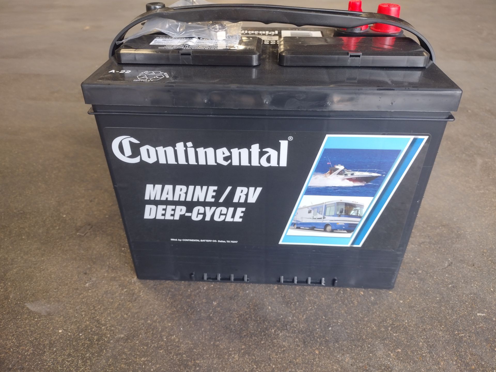 Black Continental marine/RV deep-cycle battery on a concrete surface.
