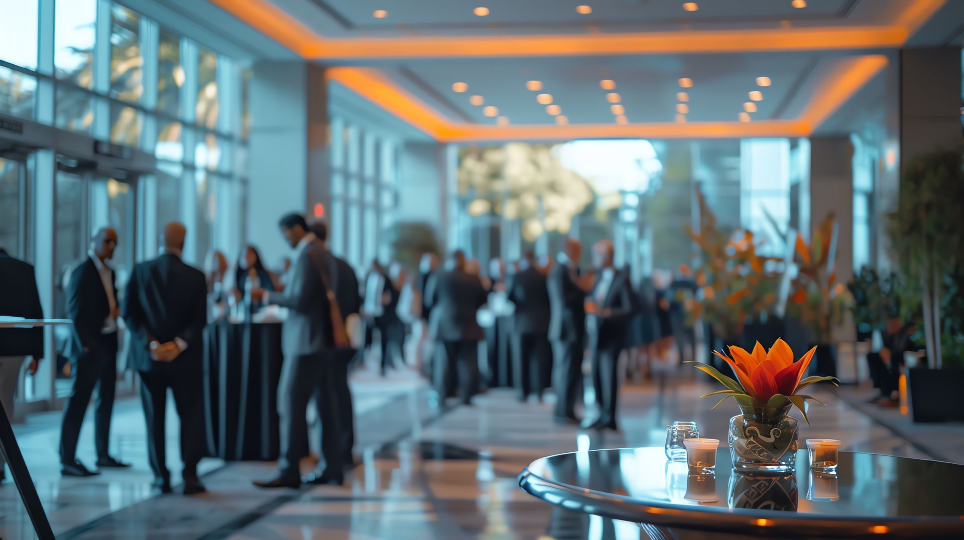 A group of people are standing around a table in a lobby.