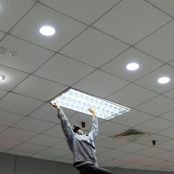 Maintenance Man Changing Office Lights — Building Maintenance in Bundaberg, QLD