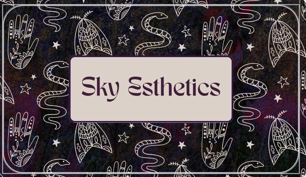 Blonde woman smiling, wearing a blue top, with a neutral background.