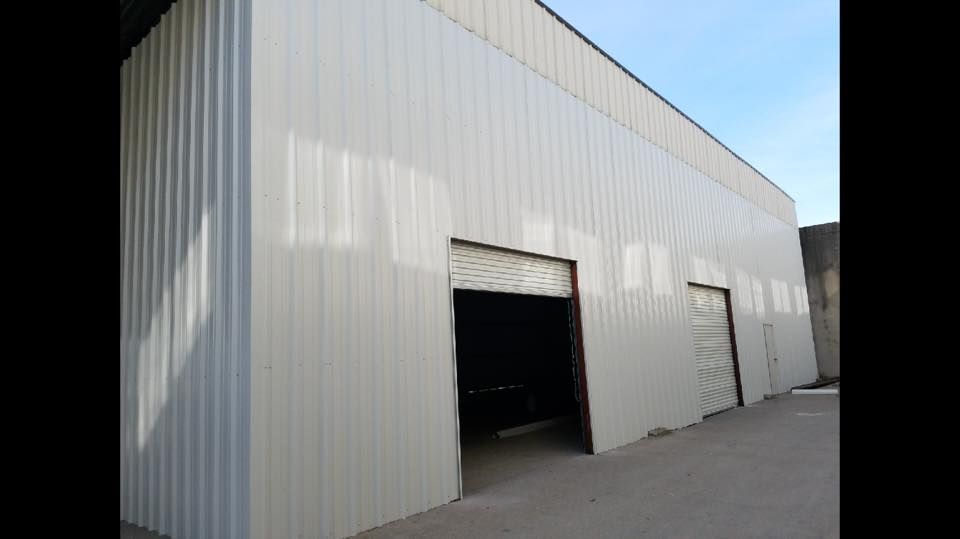 A large white building with a door that is open.