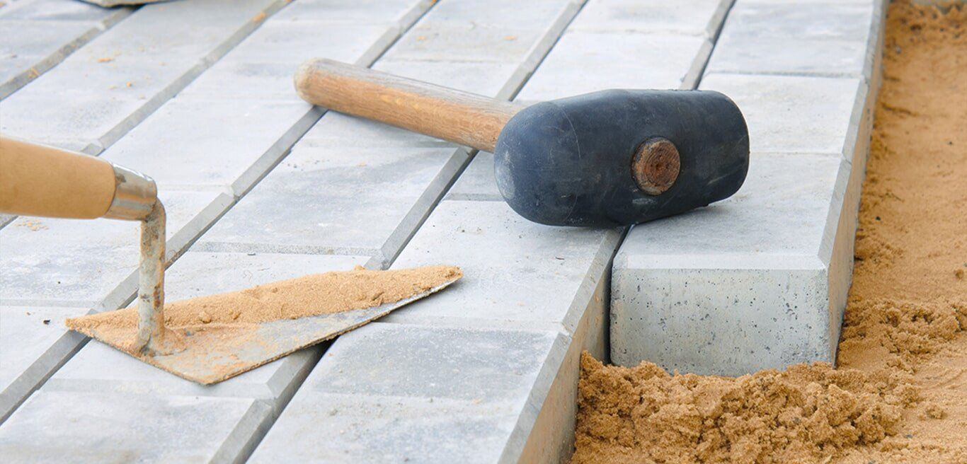 Blocklaying with trowel and hammer