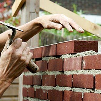Worker laying bricks and blocks