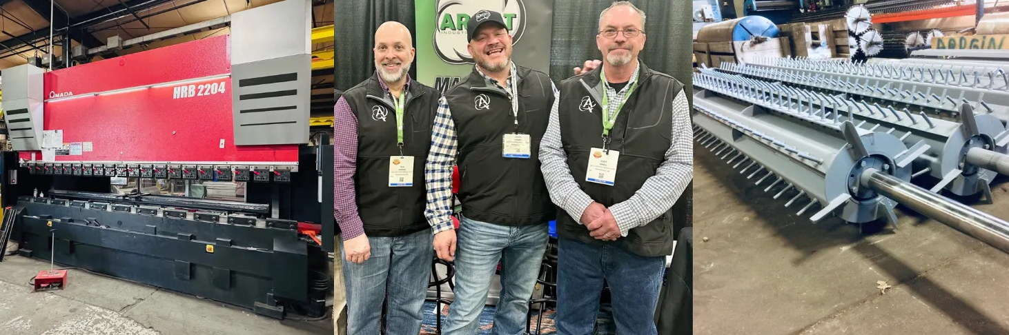 Three people in vests stand before a large red industrial press and agricultural equipment at a trade show.