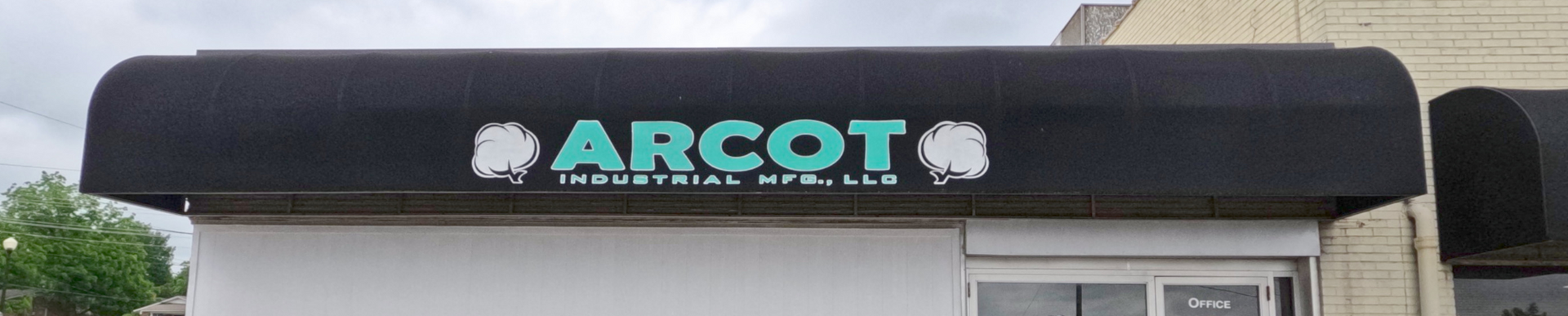 A black awning displays the name 