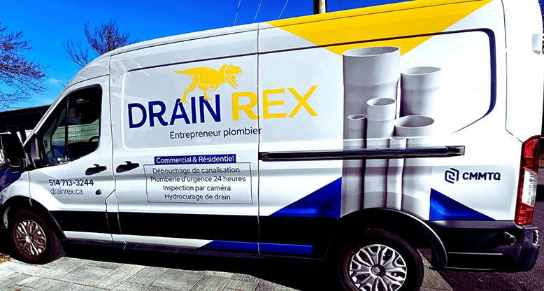 A drain rex van is parked in the snow.