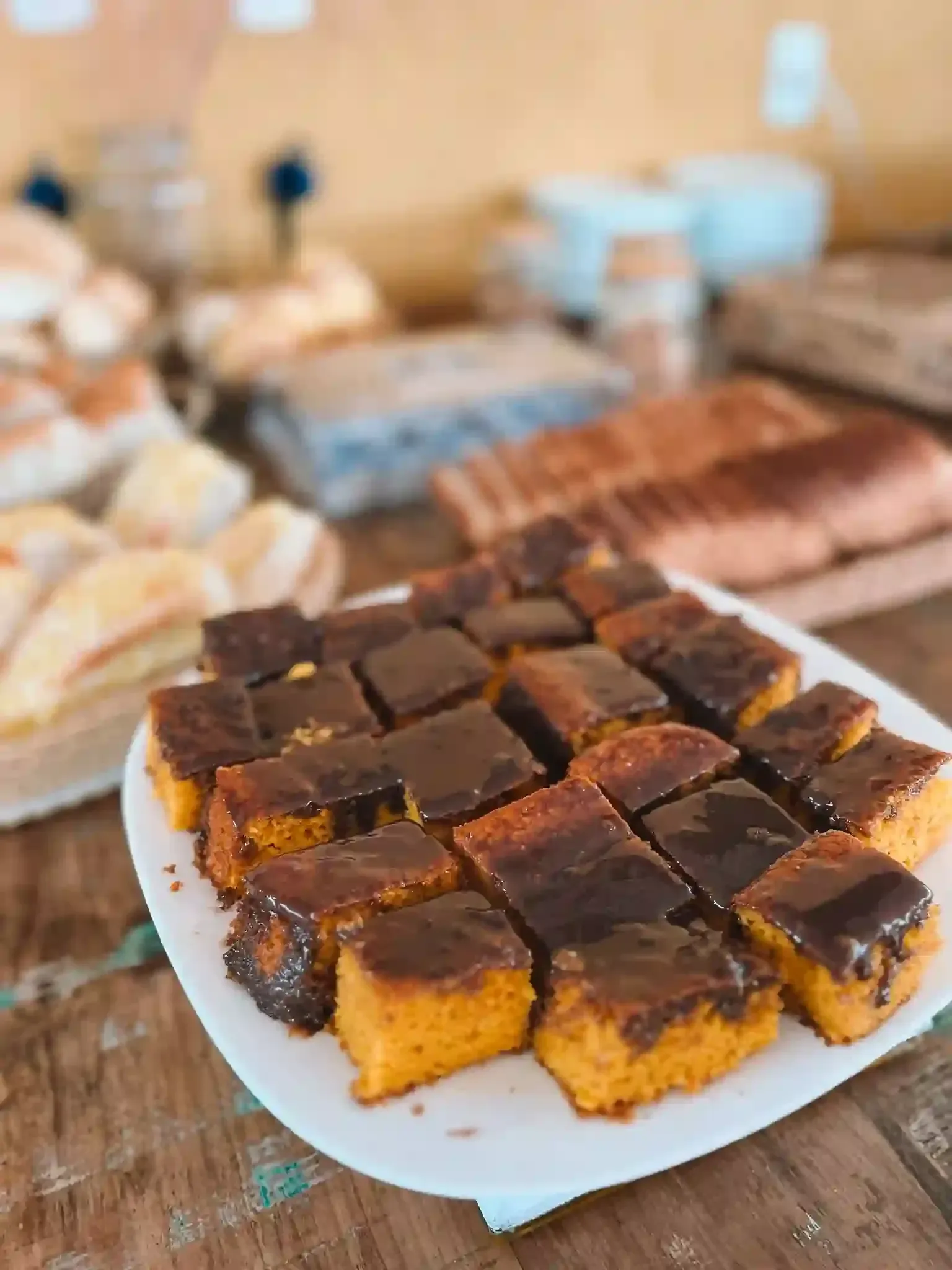 Um prato branco coberto com fatias de bolo sobre uma mesa de madeira.-pousada-itacuruca-inn