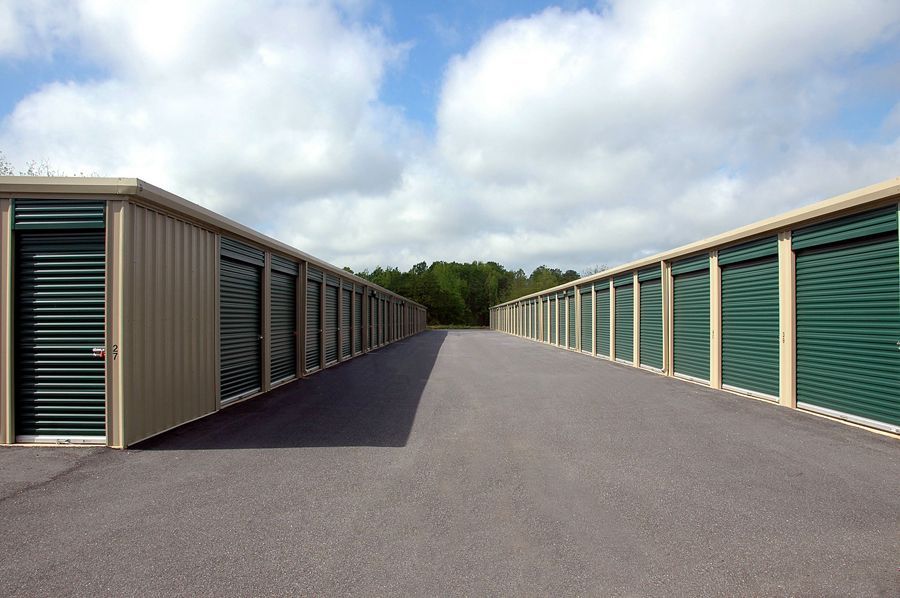 A row of storage units are lined up on the side of a road.