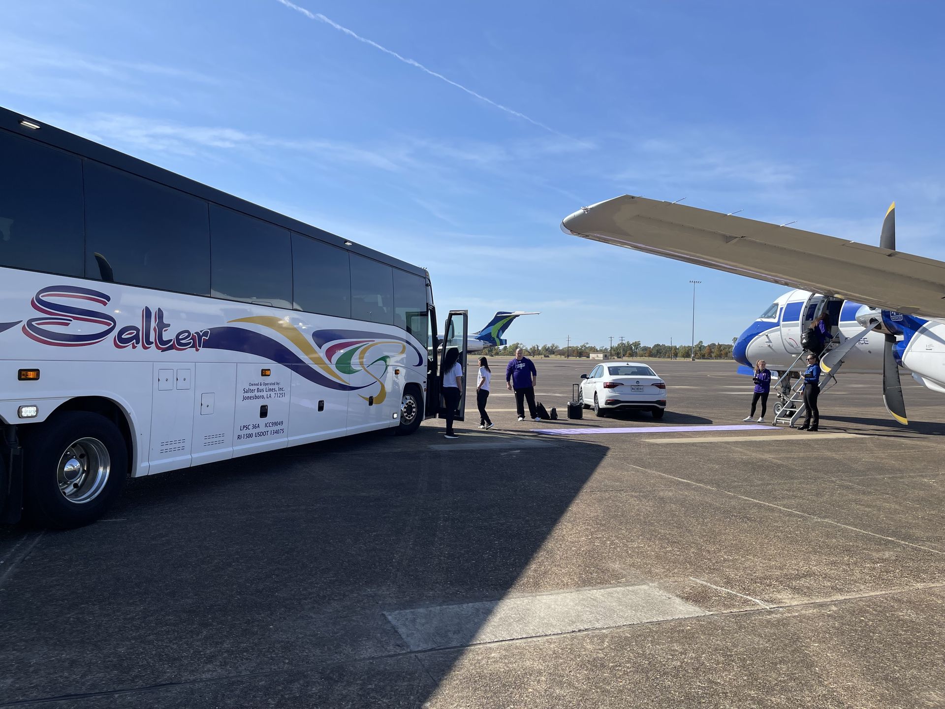 An airplane is flying over an airport terminal.
