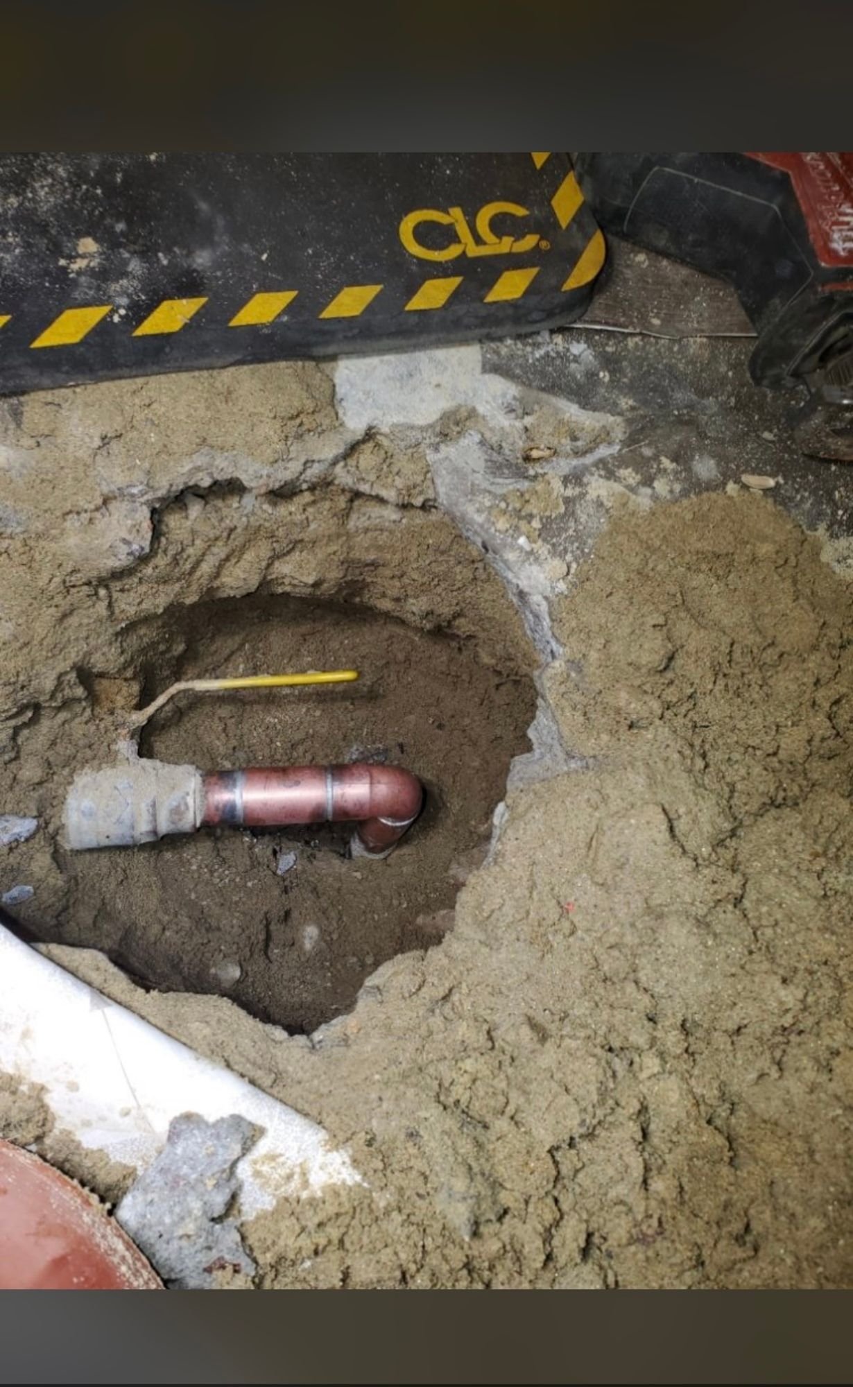 a pipe is sticking out of a hole in the ground .