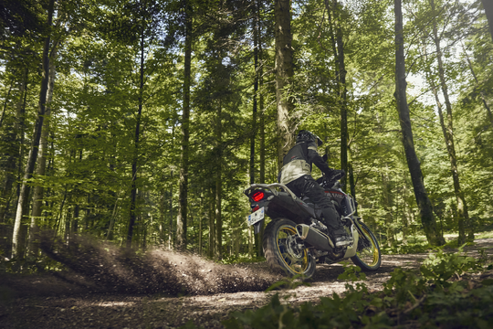 25 honda transalp riding on dirt through forest