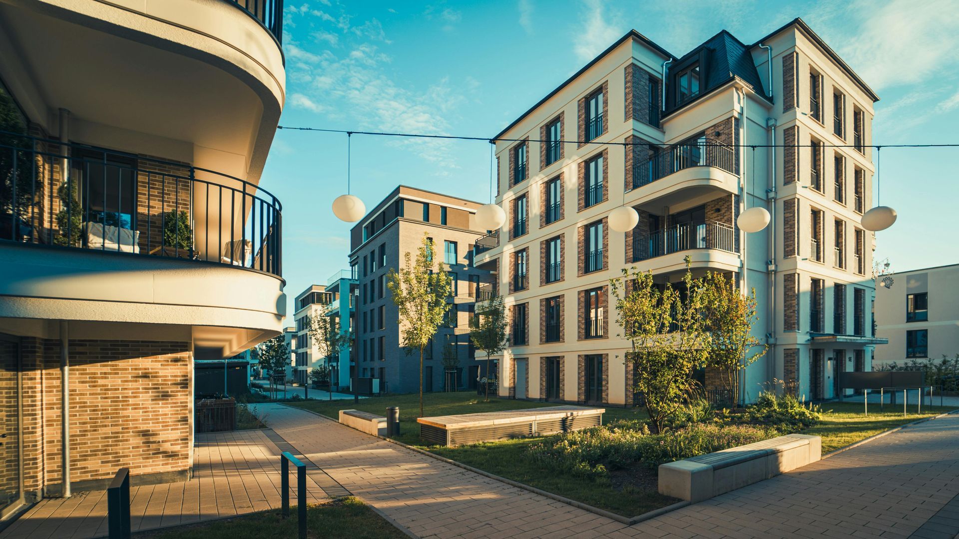 Modern apartment buildings with balconies in a sunny residential courtyard