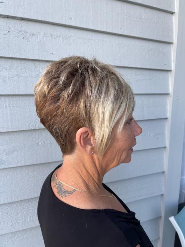 A woman with short hair and a tattoo on her back