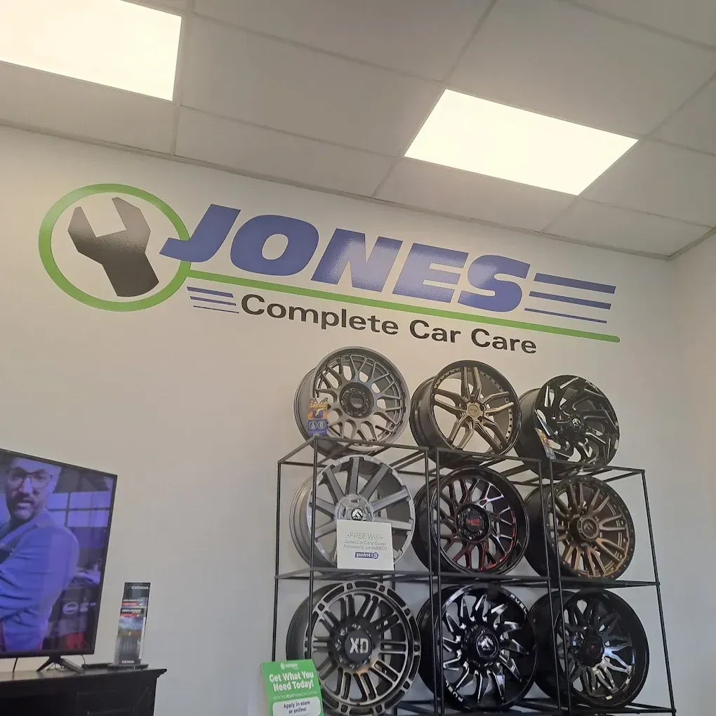 Jones Complete Car Care showroom wall with logo and display rack of custom wheels and rims | Jones Complete Car Care