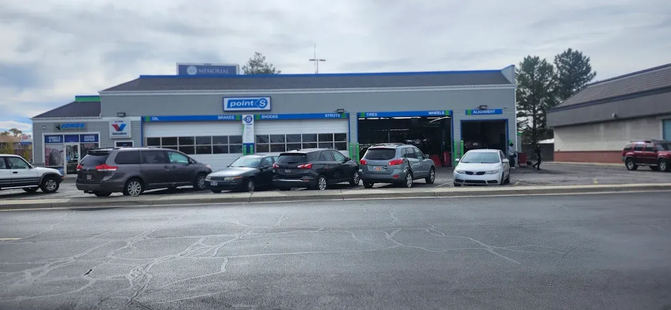 Car dealership service bay with several cars parked outside on an overcast day | Jones Complete Car Care