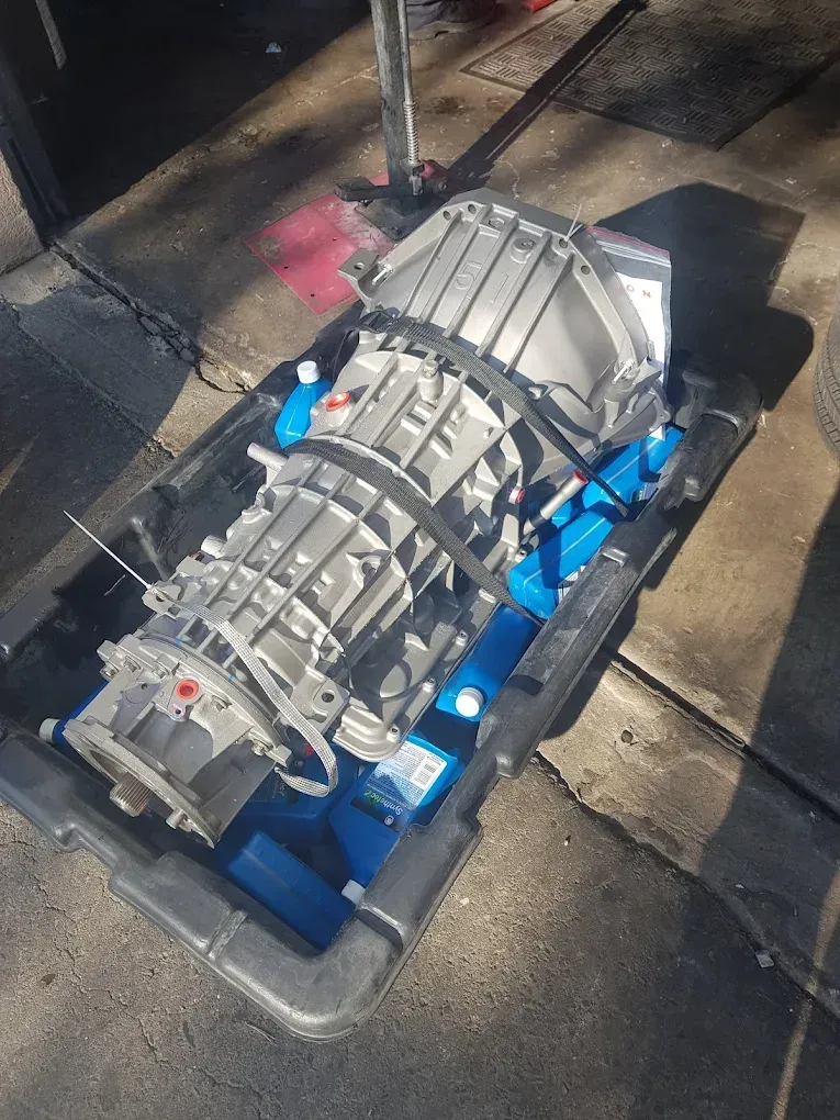 Silver transmission on a blue pallet outdoors, viewed from above. | Jones Complete Car Care