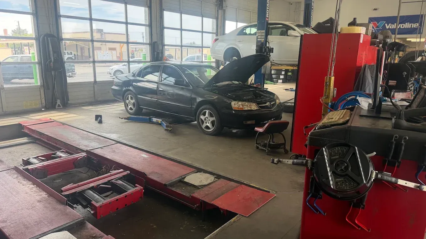 Auto repair shop with a black car on a lift and tools in the foreground | Jones Complete Car Care