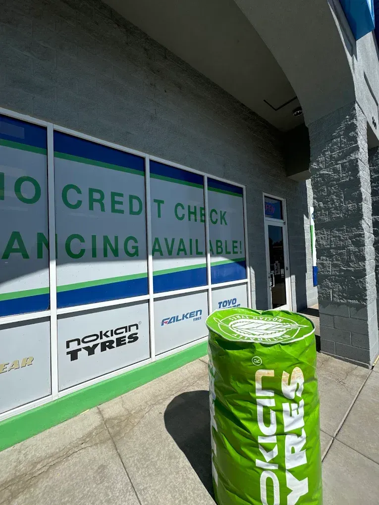 Green Nokian Tyres display barrel outside store window with financing signs. | Jones Complete Car Care
