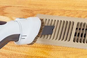 Cleaning Heater Vent with Vacuum — Vashon, WA — Vashon Heating & Cooling
