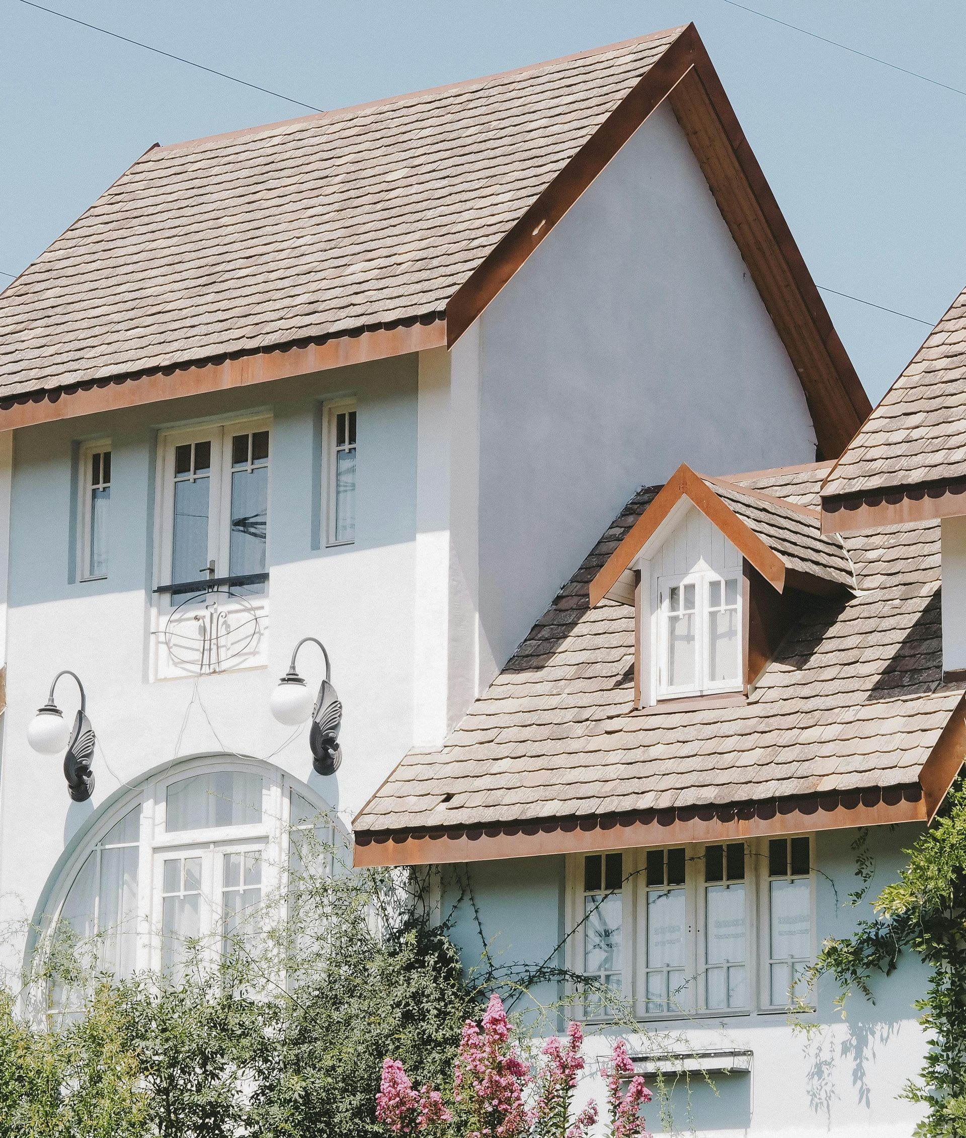 A large white house with a brown roof