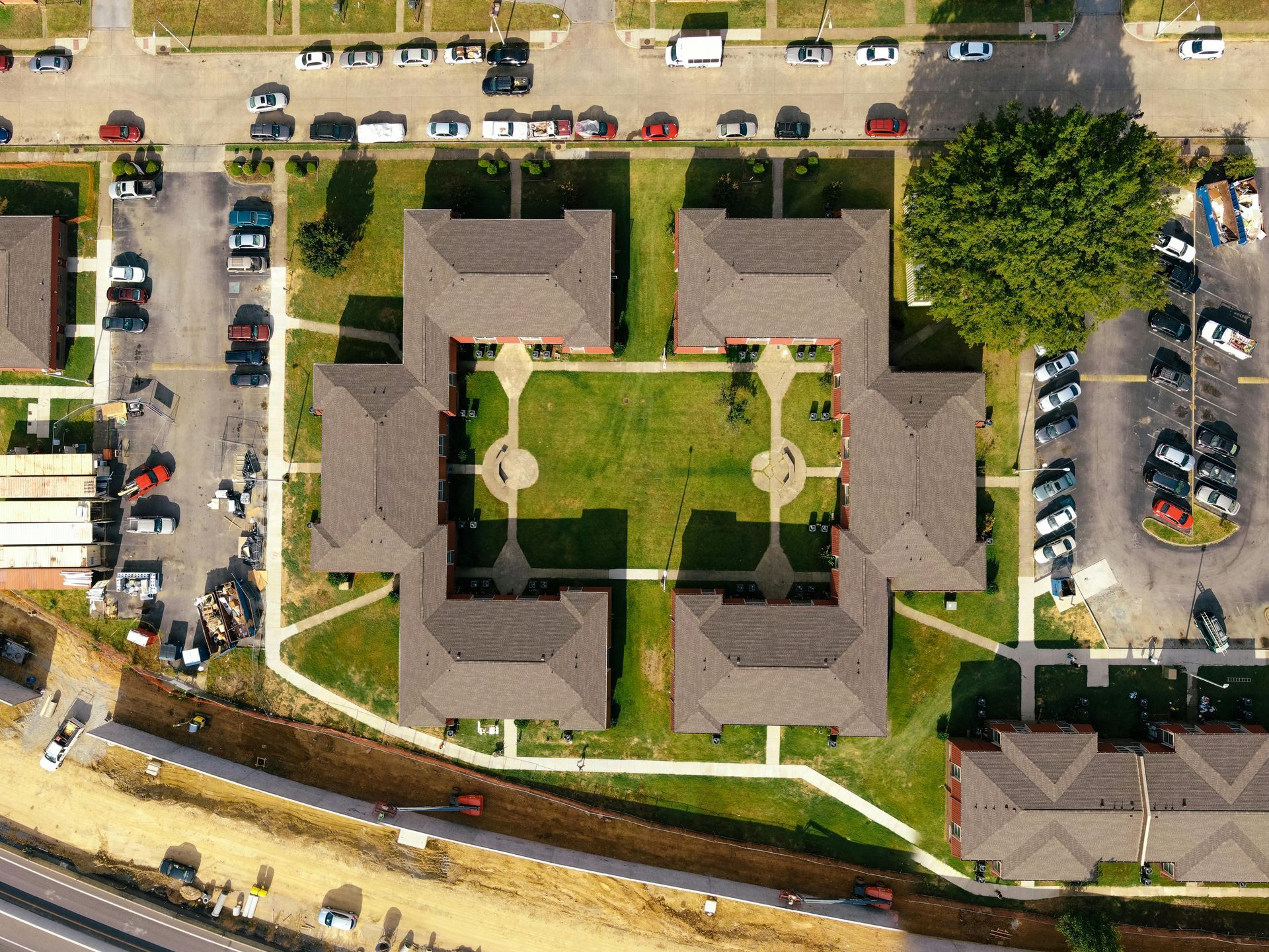 An aerial view of a residential area with lots of buildings and parking lots