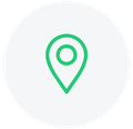 Green location pin icon centered in a white circle.