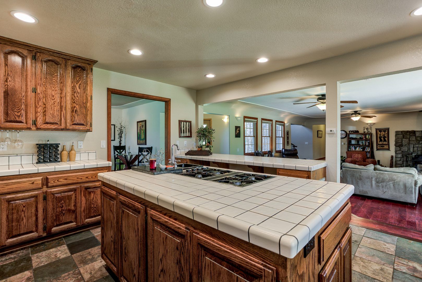 A kitchen with a large island and a stove top oven.