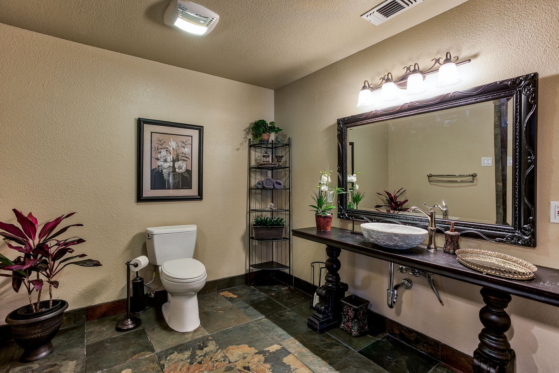 A bathroom with a toilet , sink and mirror