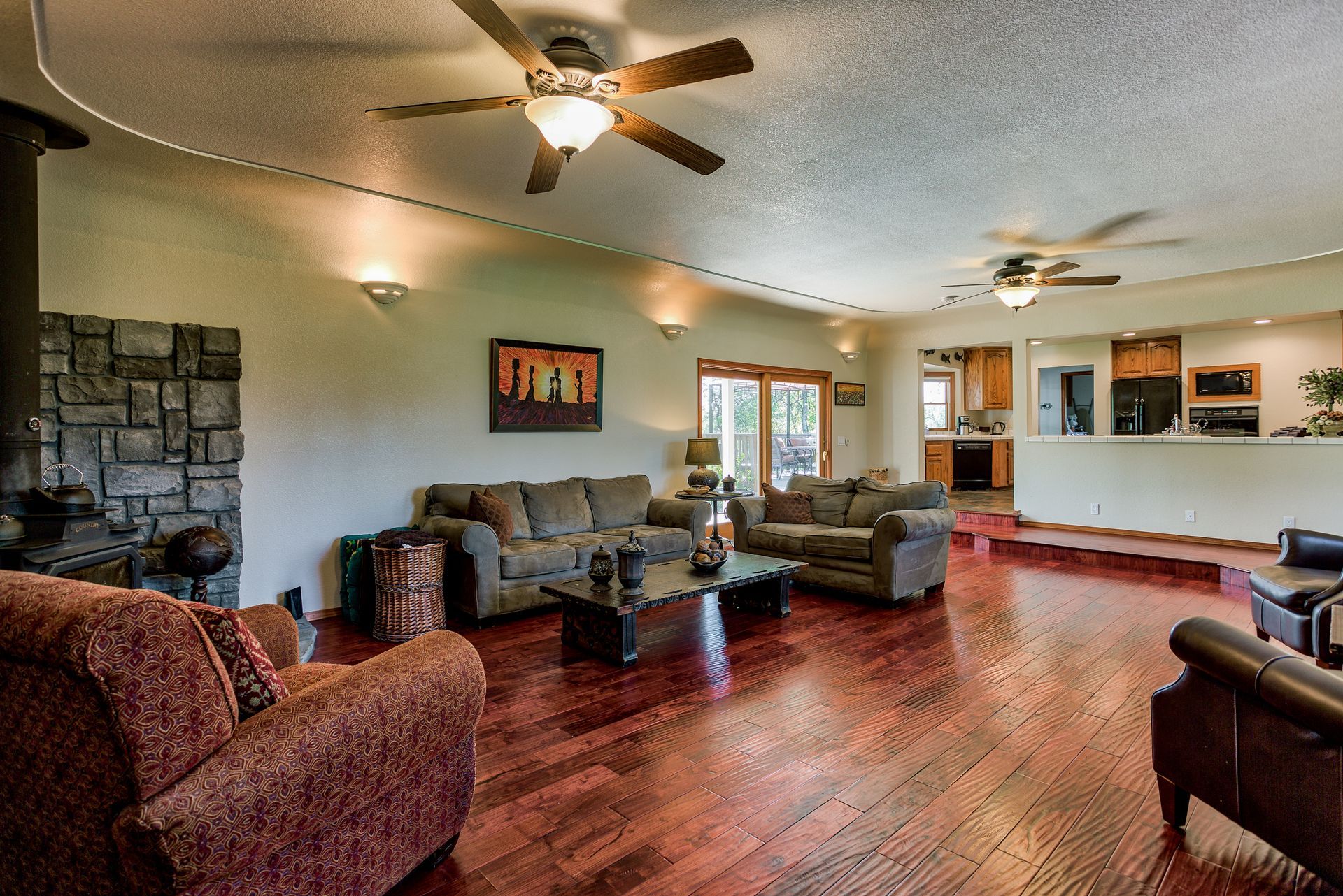 A living room with hardwood floors and a ceiling fan