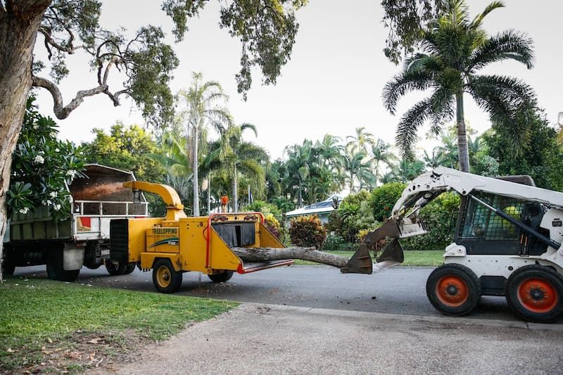 A Bobcat Pulls a Tree Chipper in Action at Tree Change NQ - Tree Services in Townsville, QLD