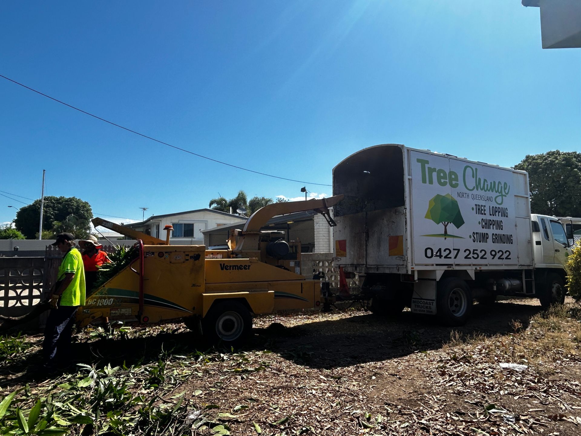 A man Expertly Uses a Crane to Trim a Tree in Townsville, Showcasing Skilled Tree Care Services by Tree Change NQ - Tree Services in Townsville, QLD