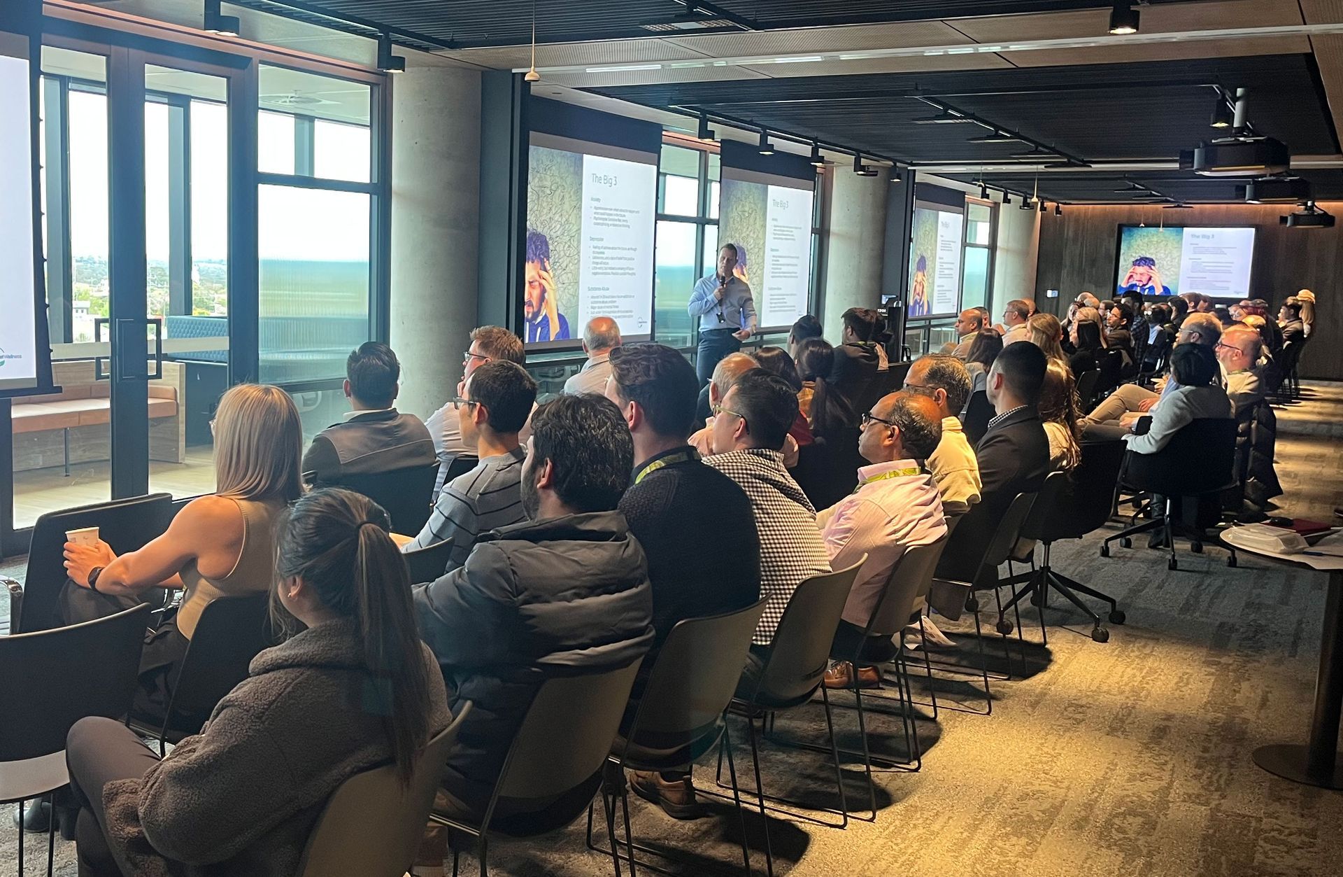 Dean Beattie is standing in front of a room full of corporate employees as he talks about the challenges of mental health in the workplace.