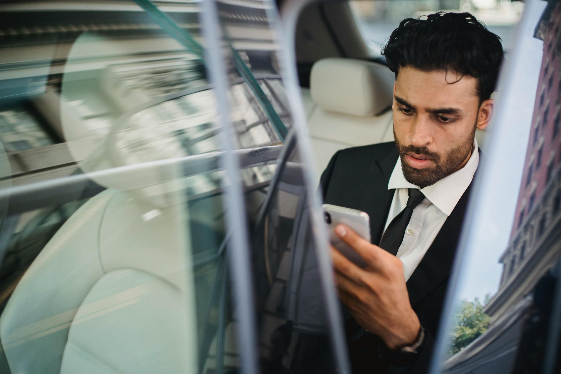 A corporate man struggling with stress and looking for solutions on his phone