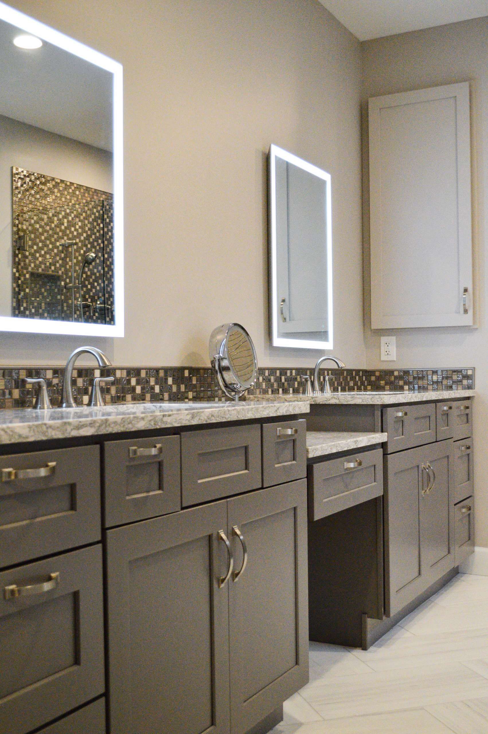 A bathroom with two sinks and two mirrors