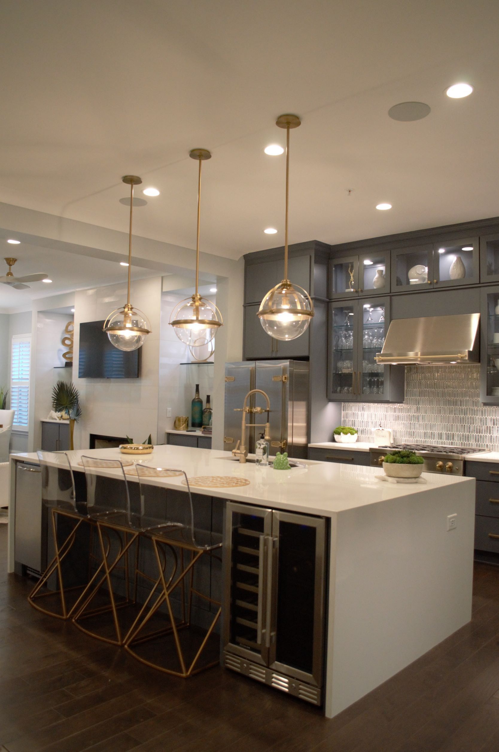 A kitchen with a large island and stainless steel appliances.