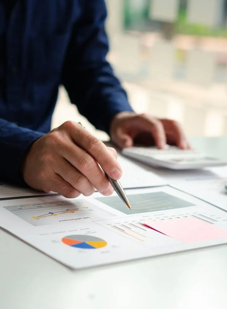 Person Reviewing Financial Data with Pen and Calculator — All Finanz & Insurance Solutions Mackay in North Mackay, QLD