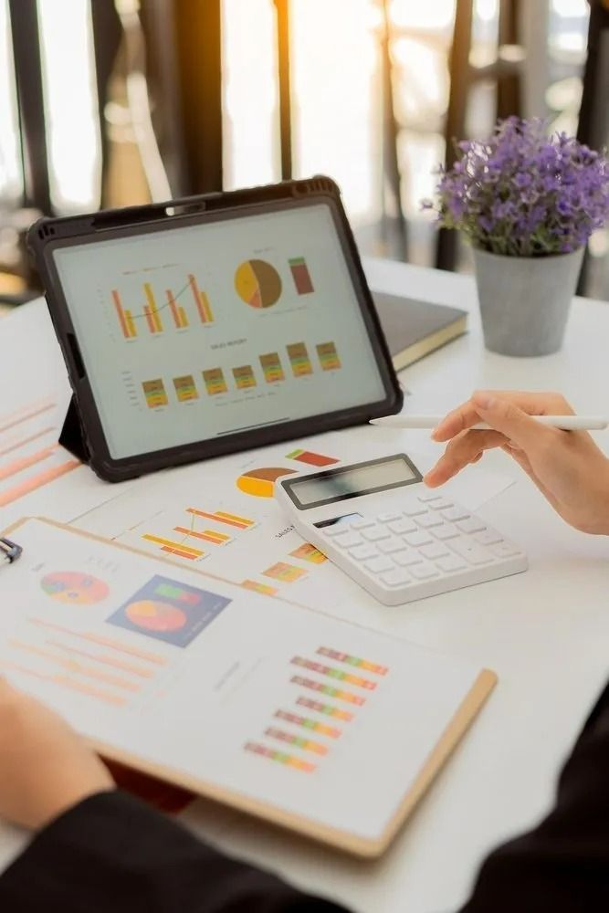 Person Working at Desk With Financial Records — All Finanz & Insurance Solutions Mackay in Moranbah, QLD