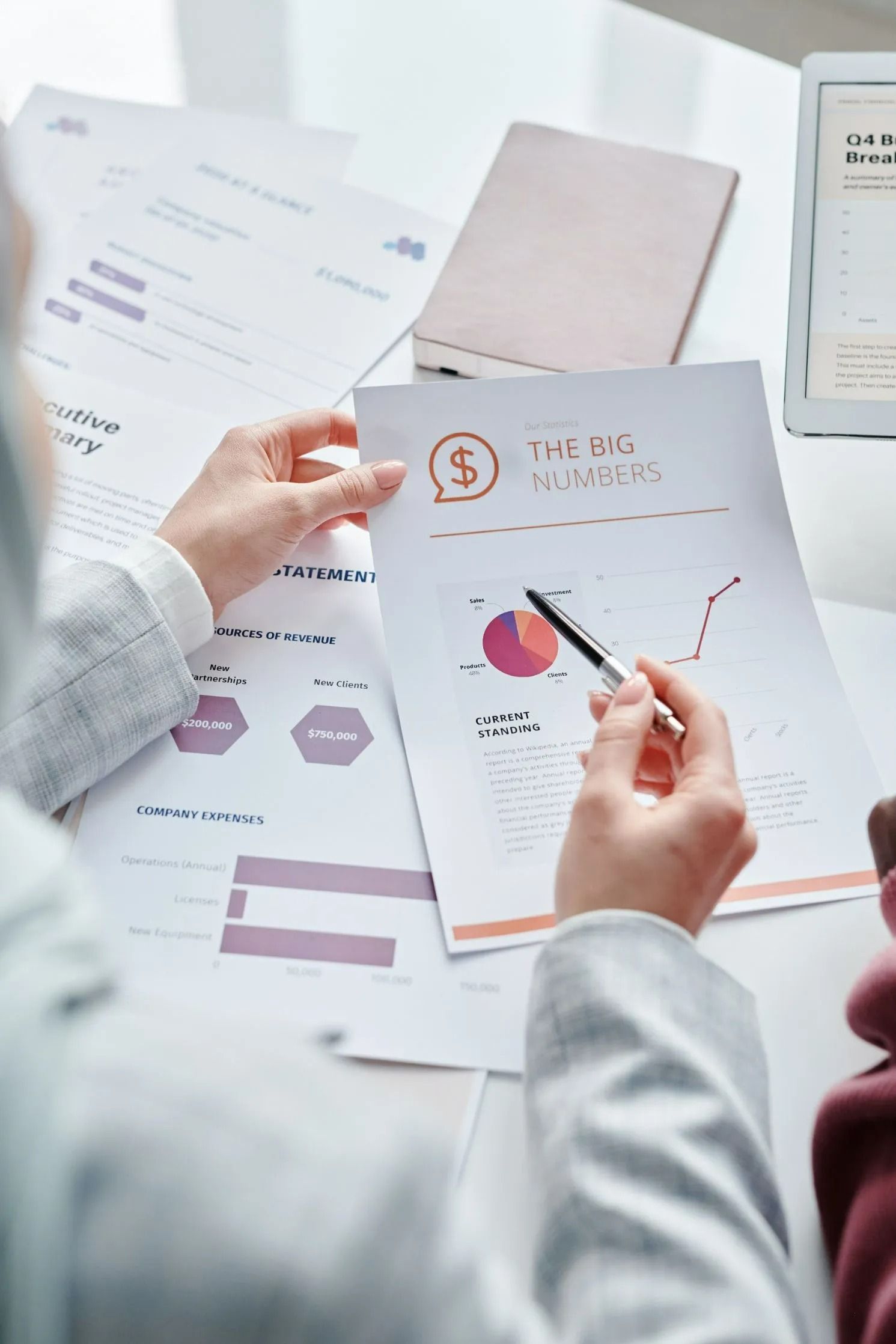 Person Reviewing Financial Charts — All Finanz & Insurance Solutions Mackay in North Mackay, QLD