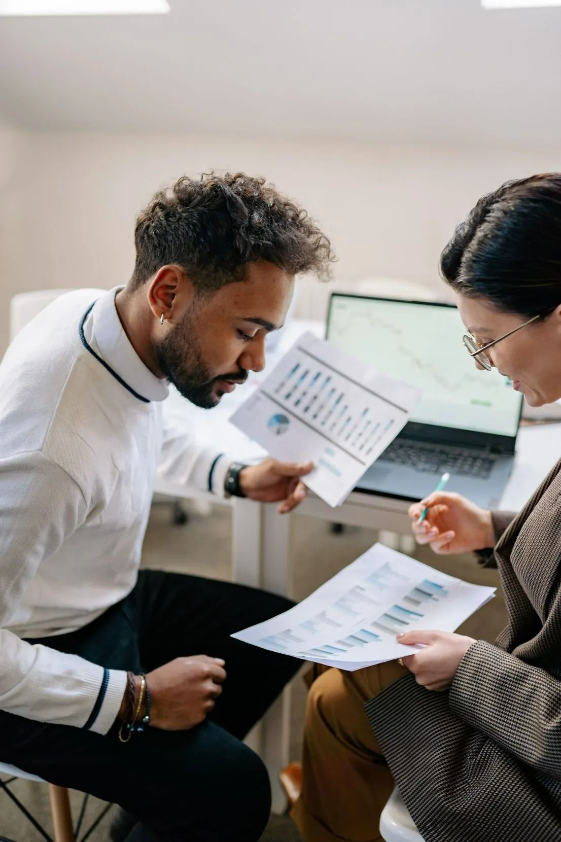 Two People Reviewing Documents at Desk — All Finanz & Insurance Solutions Mackay in North Mackay, QLD