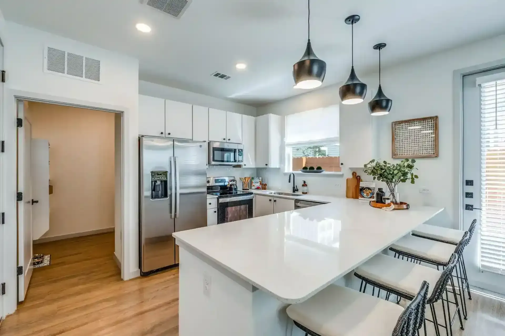 3 Bedroom Luxury Apartments in New Braunfels, TX - Villas at Creekside - A Kitchen with Stainless Steel Appliances, and a Large Island.