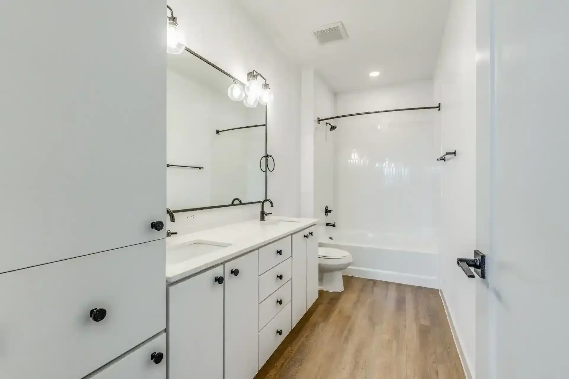 Modern bathroom with dual sinks and bathtub