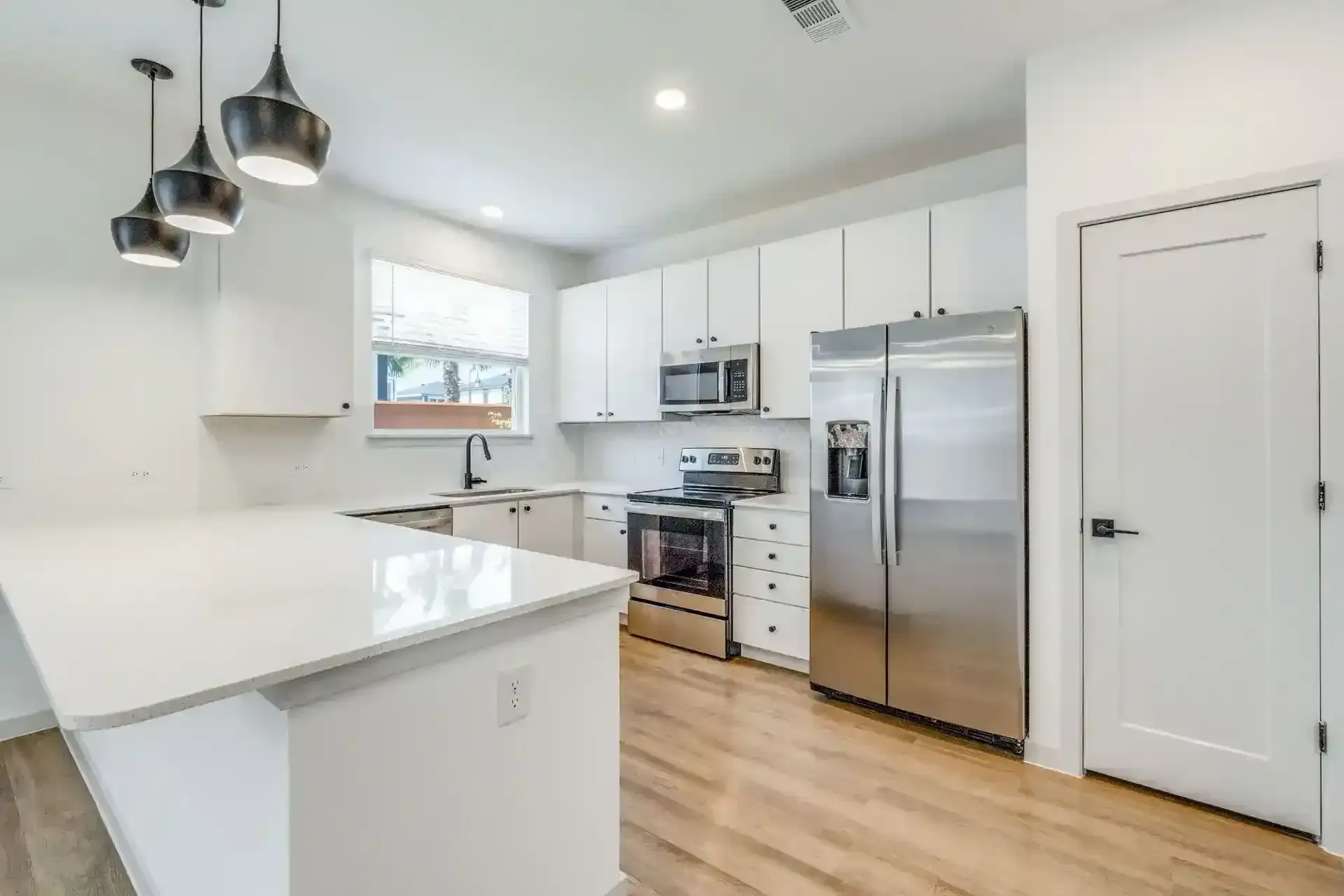 Modern kitchen with stainless steel appliances and natural light