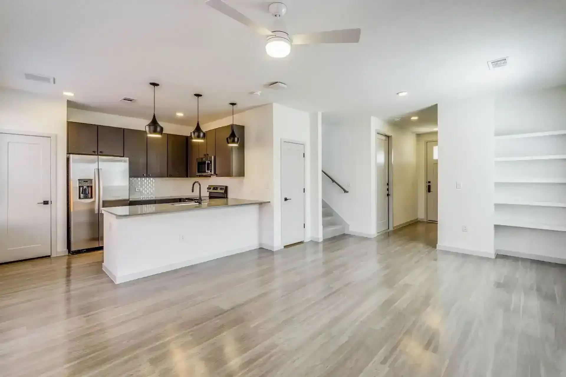 Spacious living area with kitchen and stainless-steel appliances