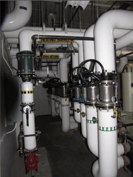 White pipes and valves in an industrial setting.