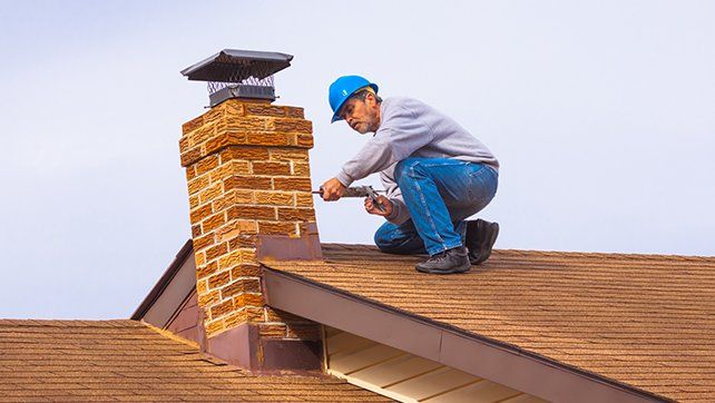 Worker Repairing Chimney — Livermore, CA — Charlie Dunn & Sons